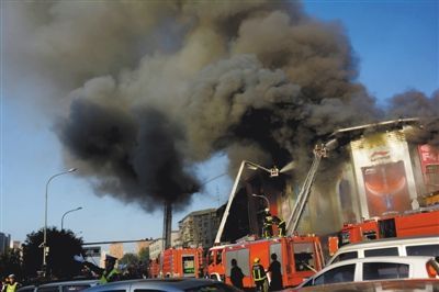 11日，蘋果園喜隆多商場，火災現場濃煙滾滾。新華社發(fā)
