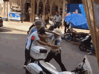 嫌疑男子涉嫌無證駕駛摩托車，且車輛違規(guī)加裝遮陽傘并在行駛時不戴安全頭盔，辱罵毆打執(zhí)法交警。 本文圖片均來自 廣西梧州在線警務