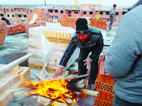 在俄羅斯工地打工時(shí)，因?yàn)樘焯?，工人不得不在工地生火取暖。（圖由方先生提供）