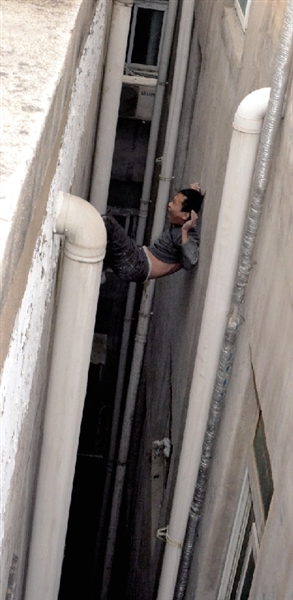 就在民警緊急施救時，他從兩樓之間摔下。