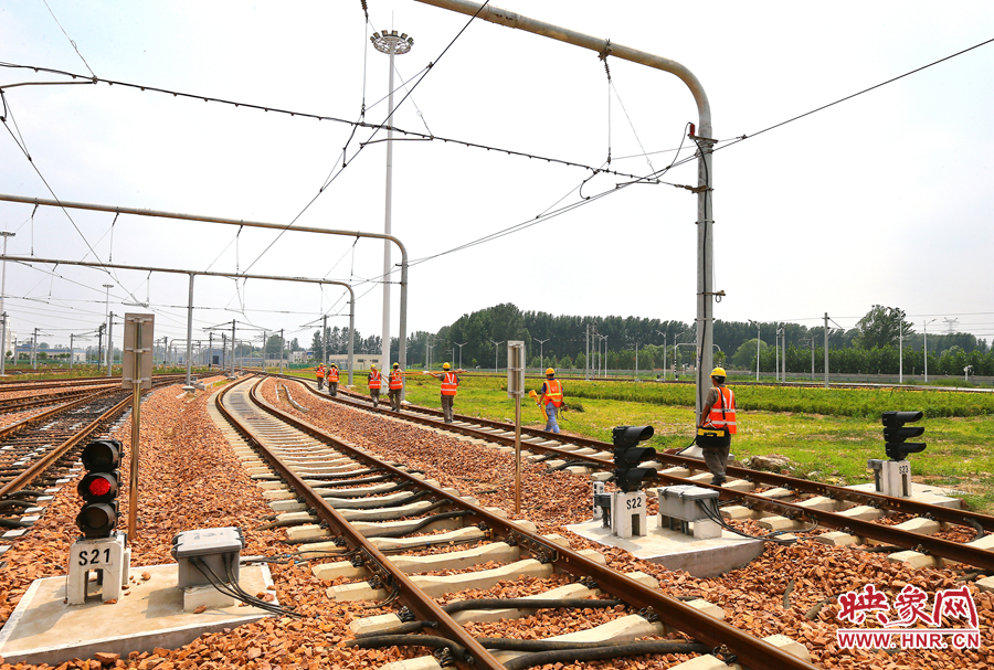 在太陽的直射下，檢修工人扛著沉重的設(shè)備向施工地點(diǎn)出發(fā)