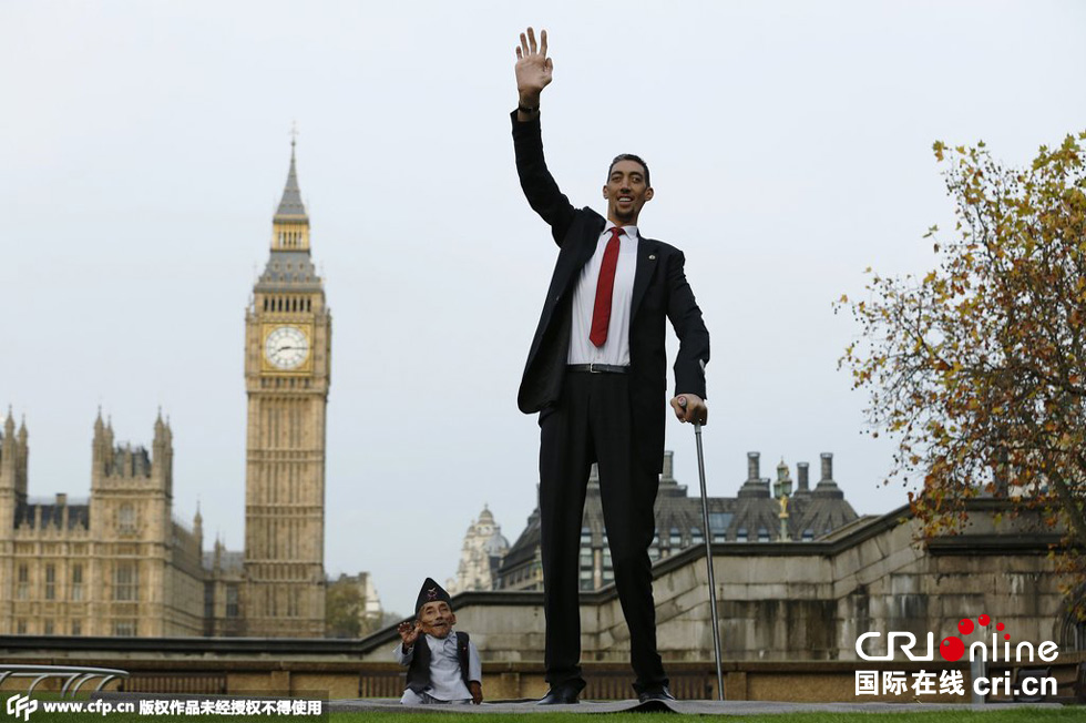 當地時間2014年11月13日，英國倫敦，世界上最矮的男子錢德拉·巴哈杜爾·唐吉與世界上最高的男子蘇