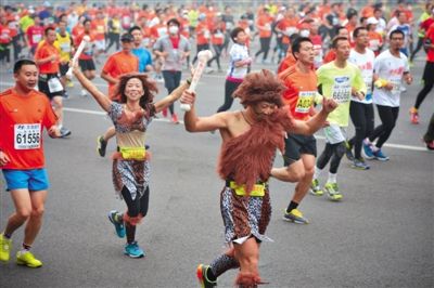 “原始人”打扮的參賽者向觀眾揮手。