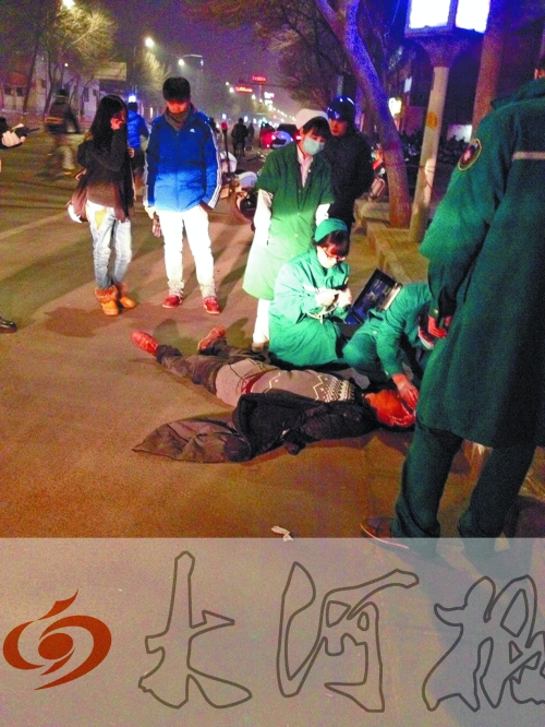醉漢躺在地上，醫(yī)護人員對其進行檢查。
